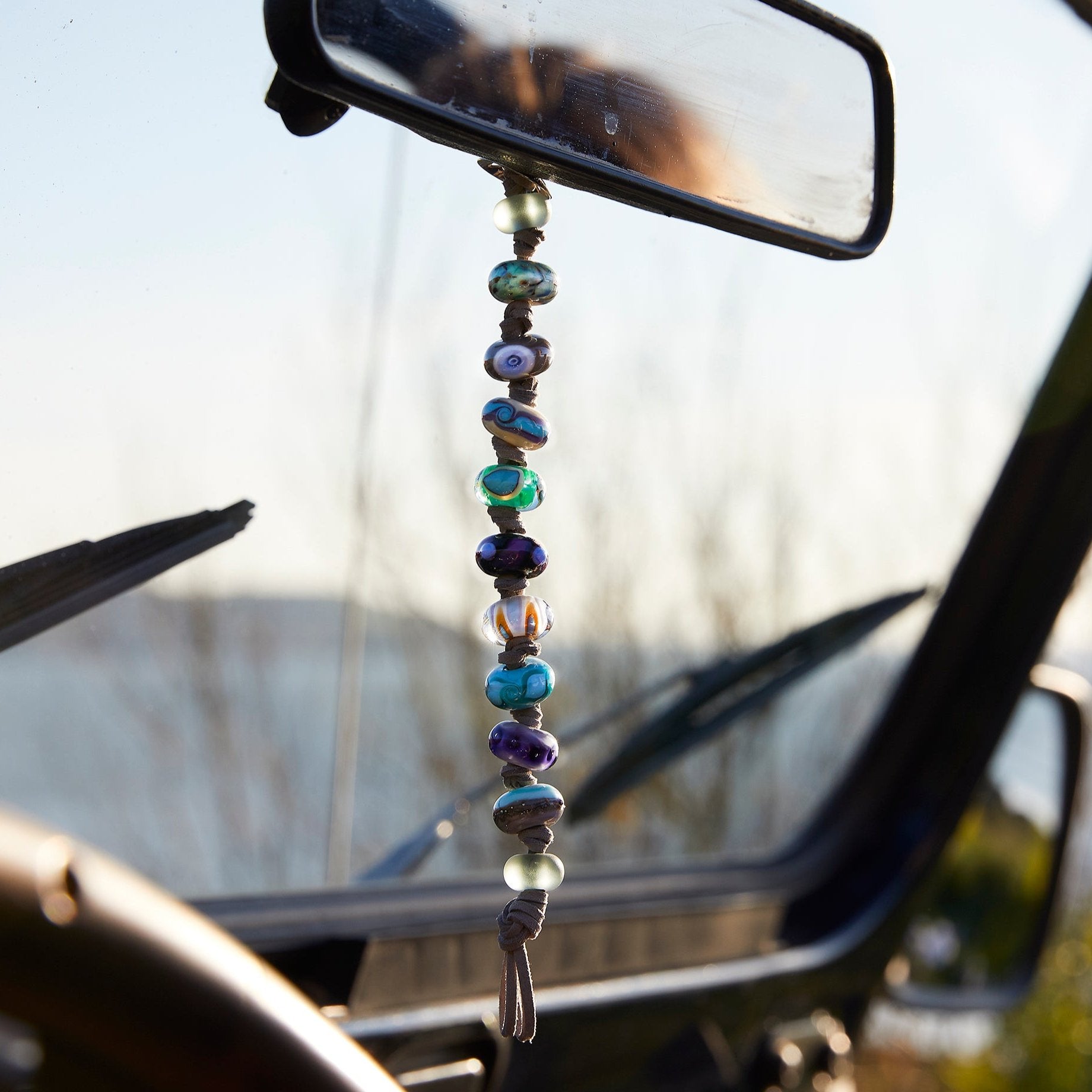 Bead string hanging on car window at Marine Drive in Woolacombe.