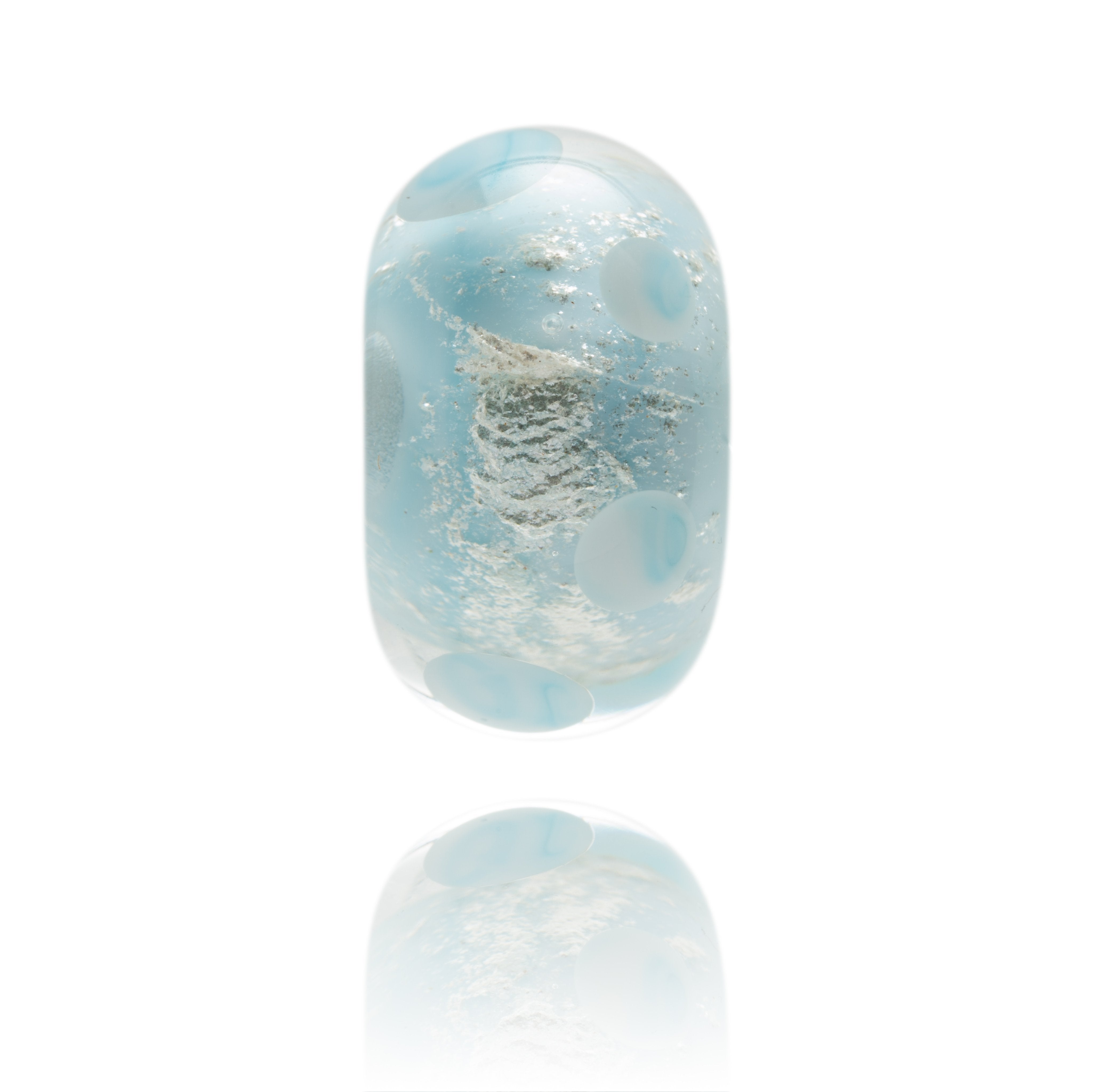 Light blue sparkly bead decorated with clear glass and dots. This glass bead represents Anglesey in Wales.