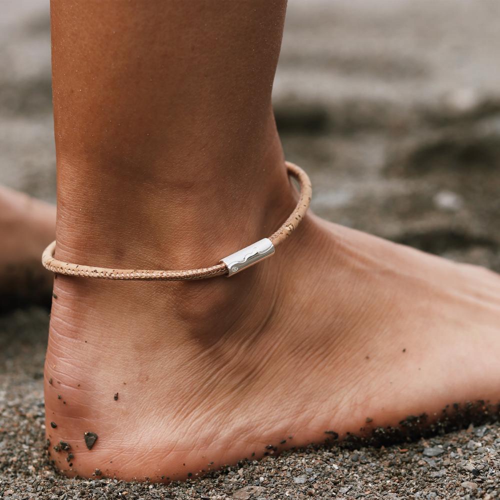 Silver tube coastline bead worn on natural cork anklet.