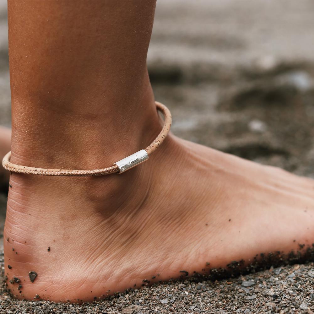 person wearing cork anklet with silver coastline.