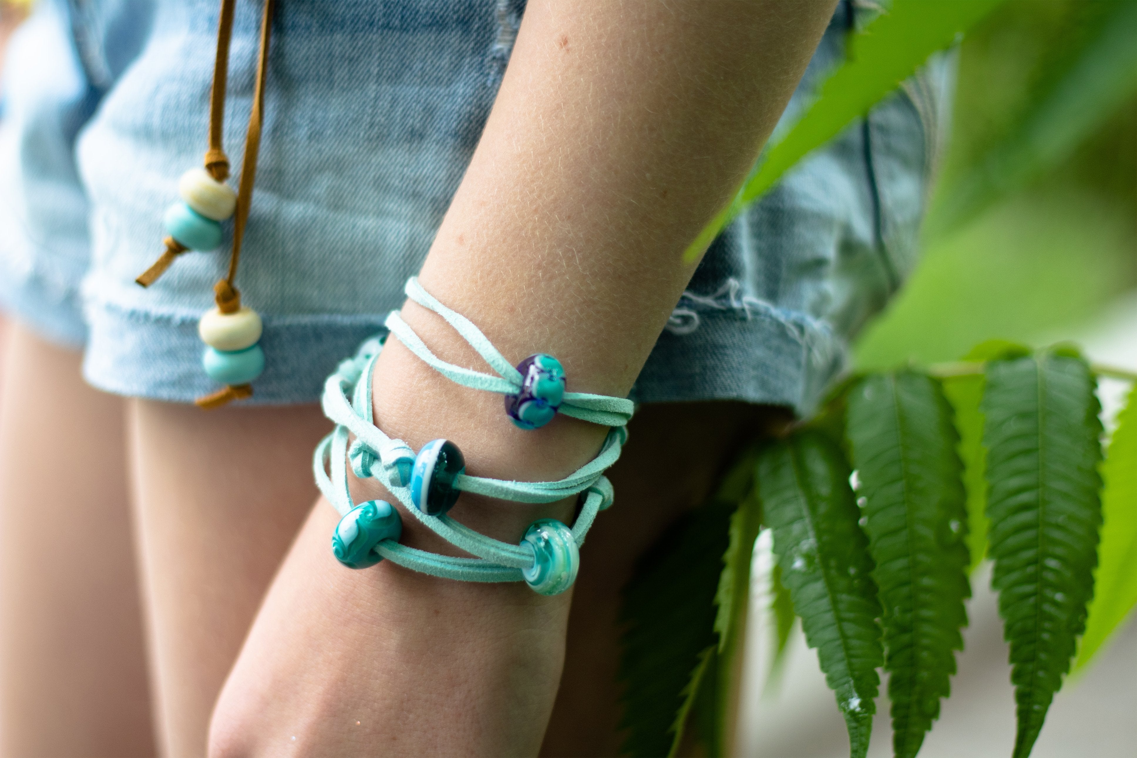 Mint cord bracelet with blue beach themed glass beads.