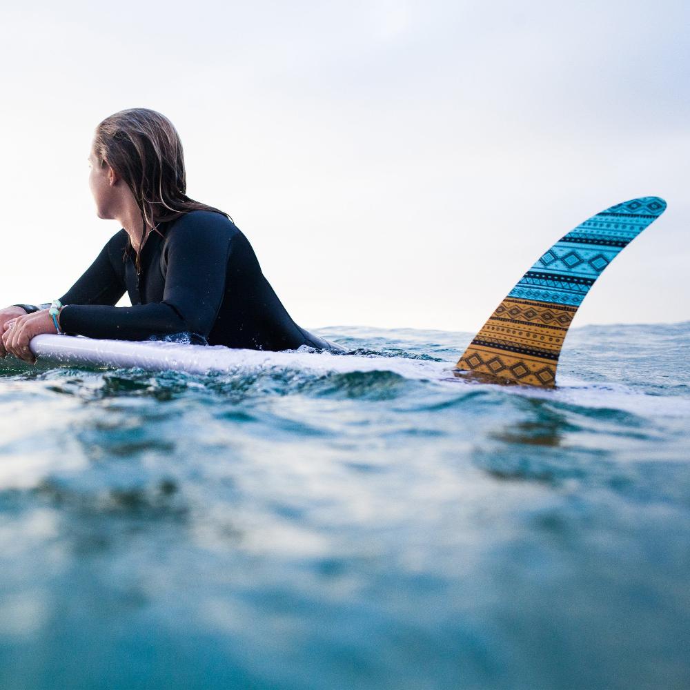 Surfer with surfboard in the sea.