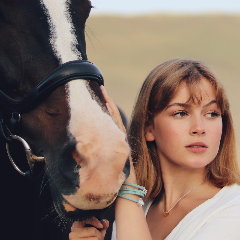 Girl with horse at the beach.