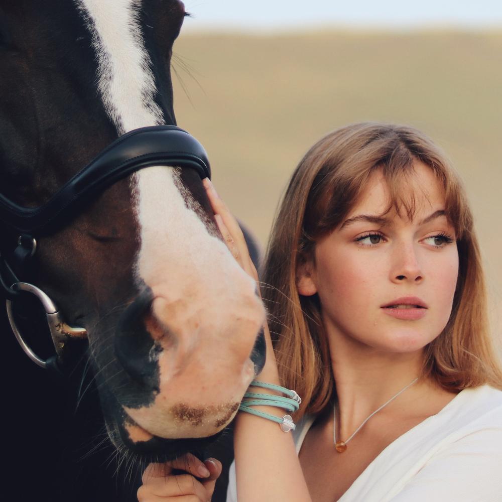 Girl with horse on the beach.