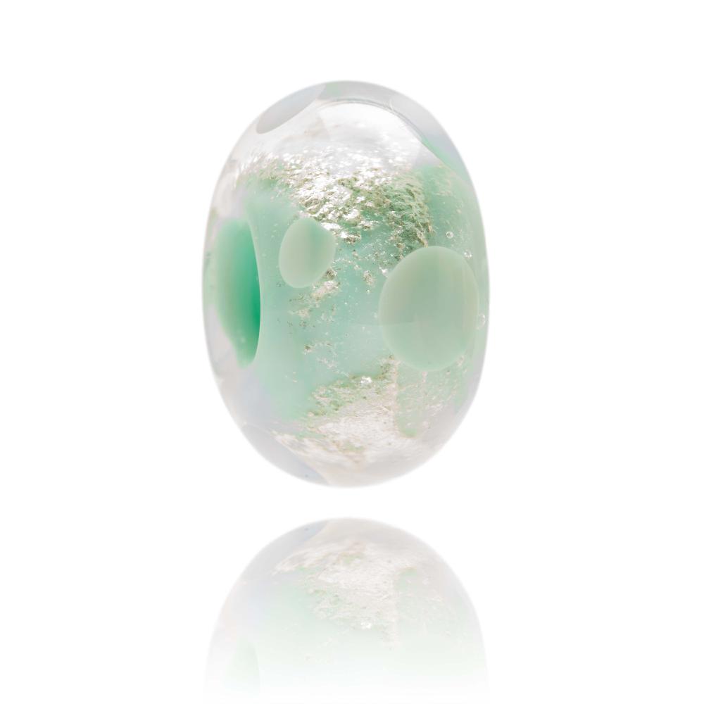 Pale green glass bead with shimmering core and green dots on surface, representing Lundy Island in North Devon.