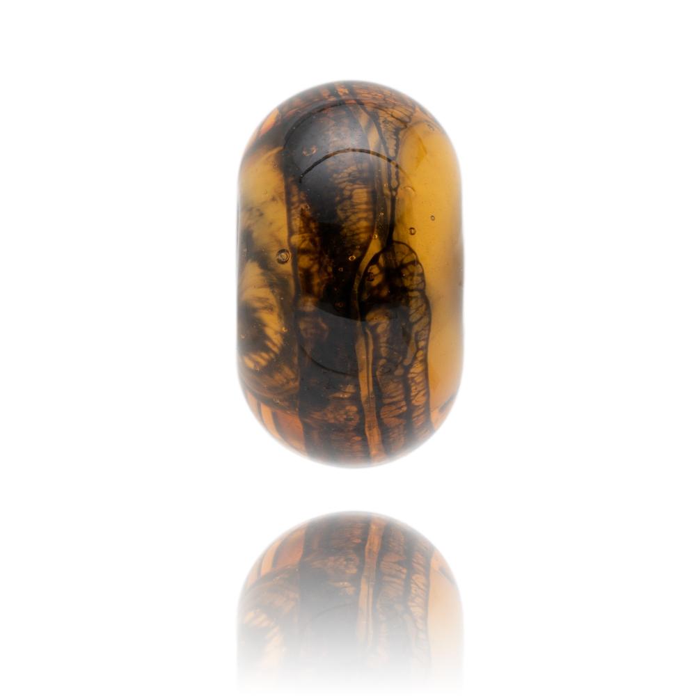 Amber glass bead with black webbing type patterns inside it, representing Lyme Regis own Dorset.