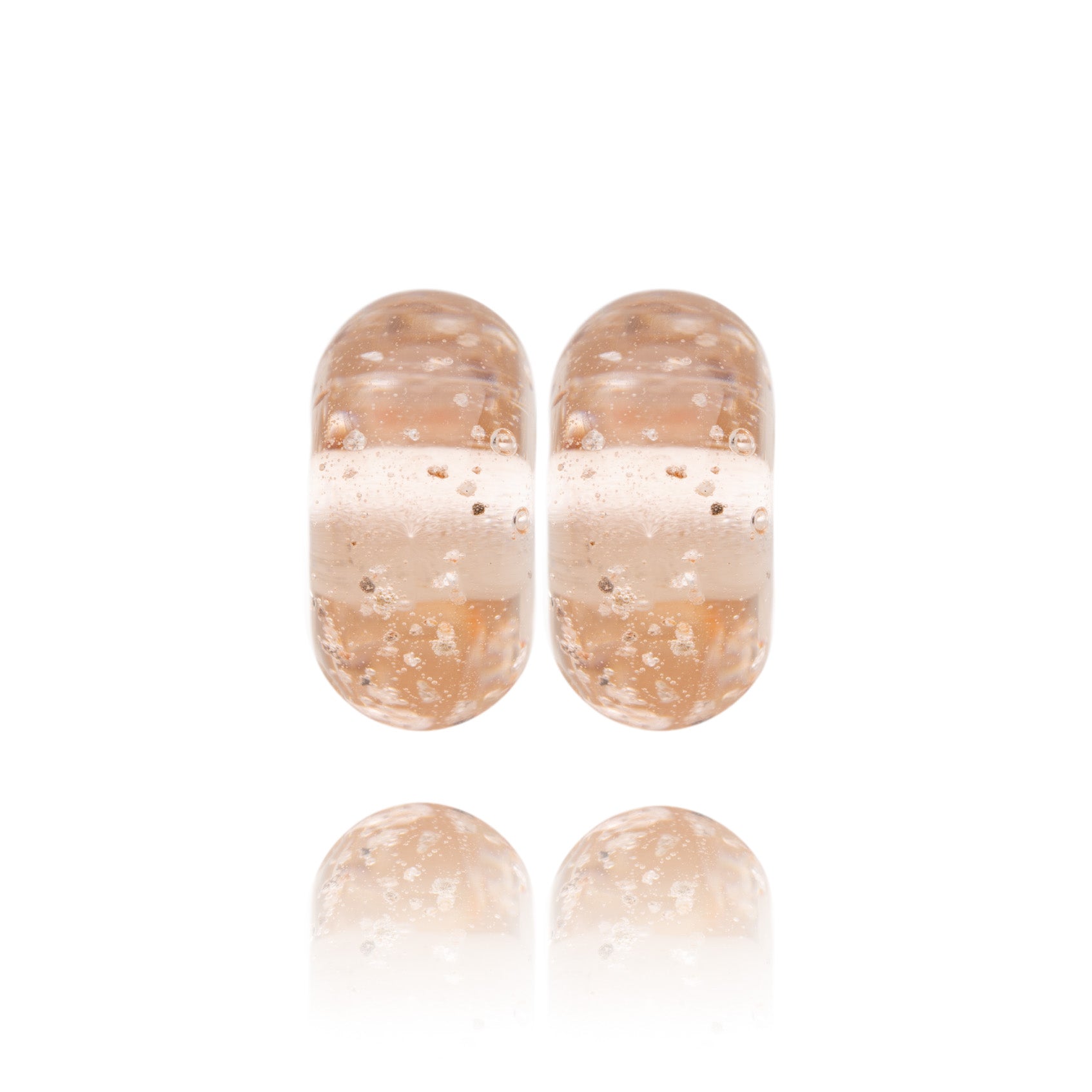 Peach coloured glass beads made with grains of beach sand melted into the glass.