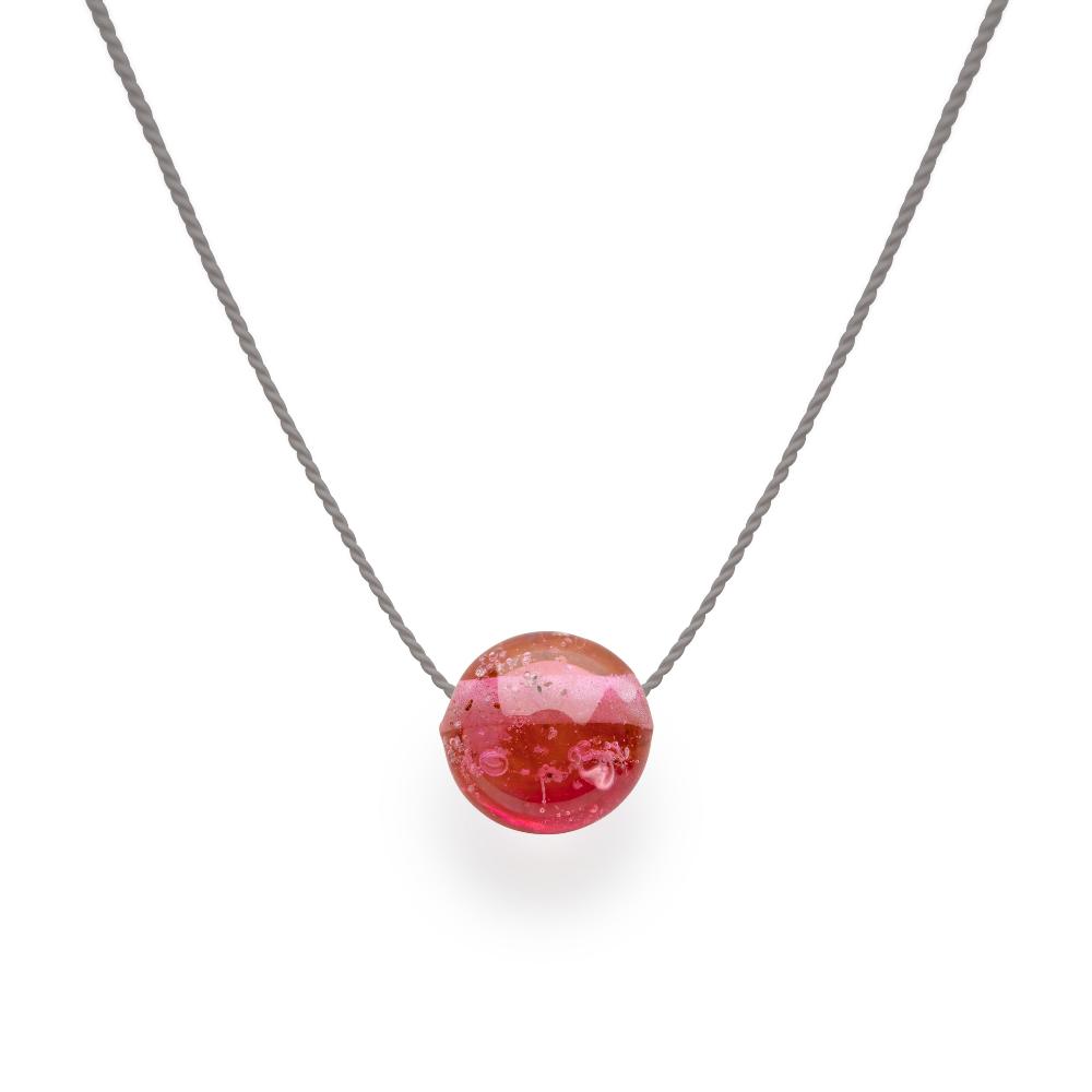 Dark Pink glass bead with grains of sand melted in the glass, strung on a silk cord.