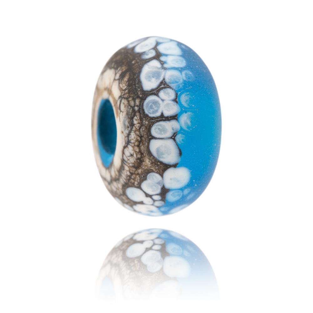 Brown and turquoise glass bead with white spots on the surface, representing a painting called Power Of Polzeath by Gemma Lessinger.