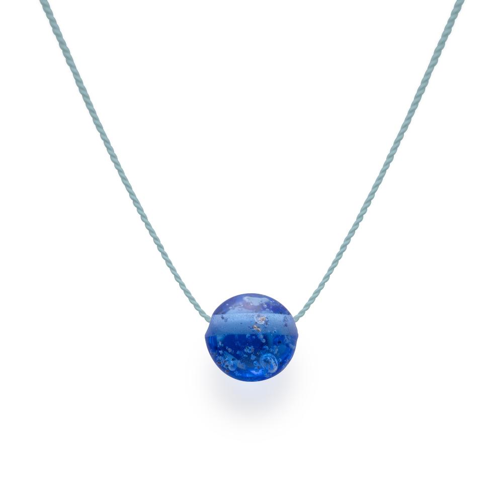 Dark Blue glass bead with grains of sand melted in the glass, strung on a silk cord.