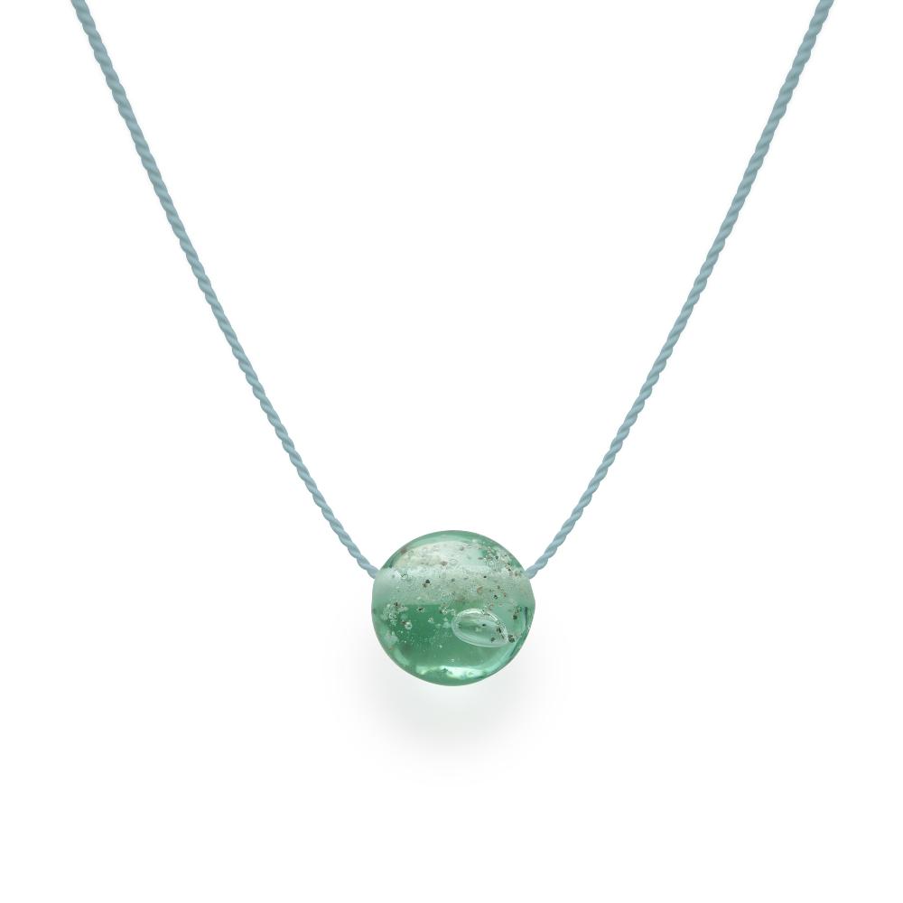 Sea glass green glass bead with grains of sand melted in the glass, strung on a silk cord.