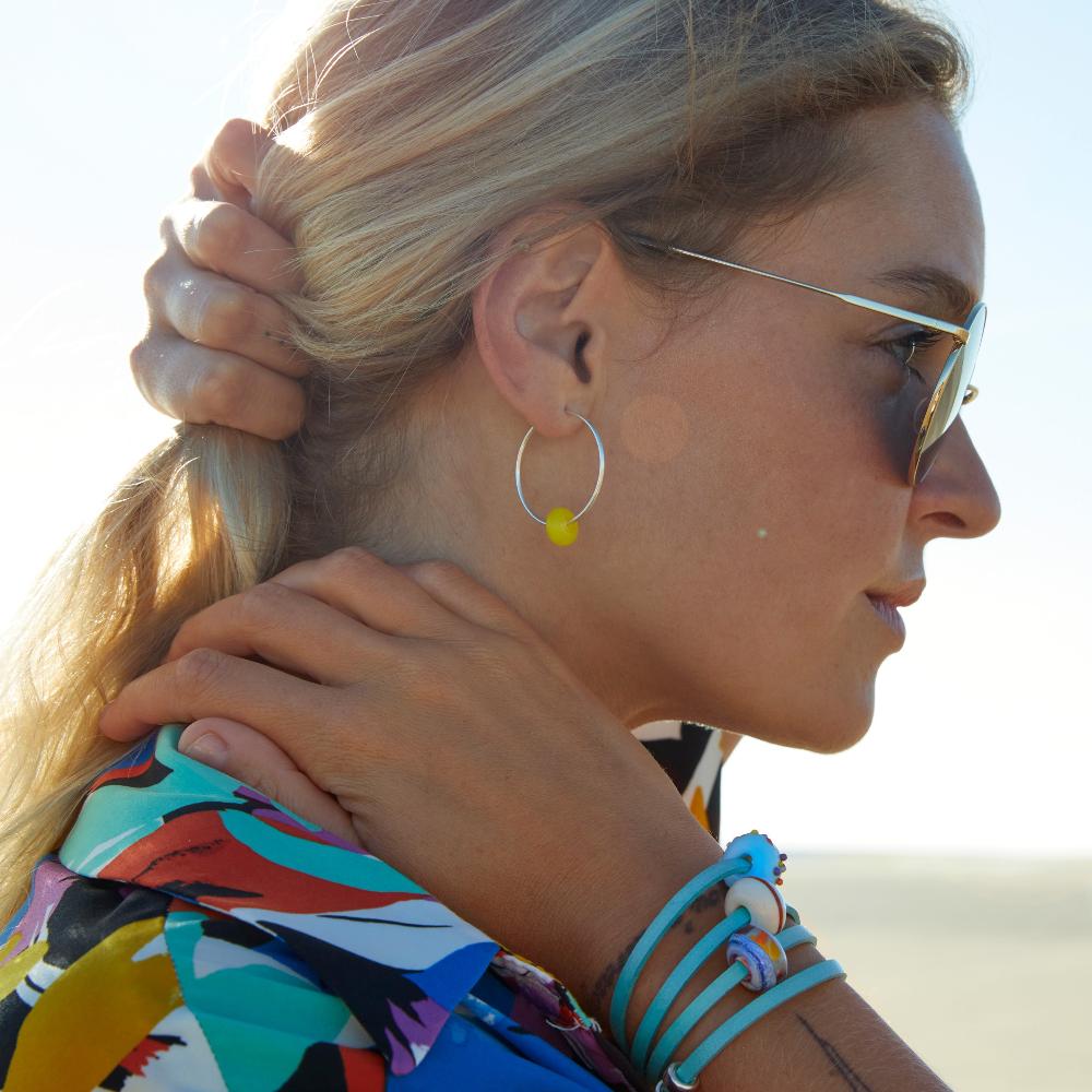 Girl wearing turquoise bracelet.