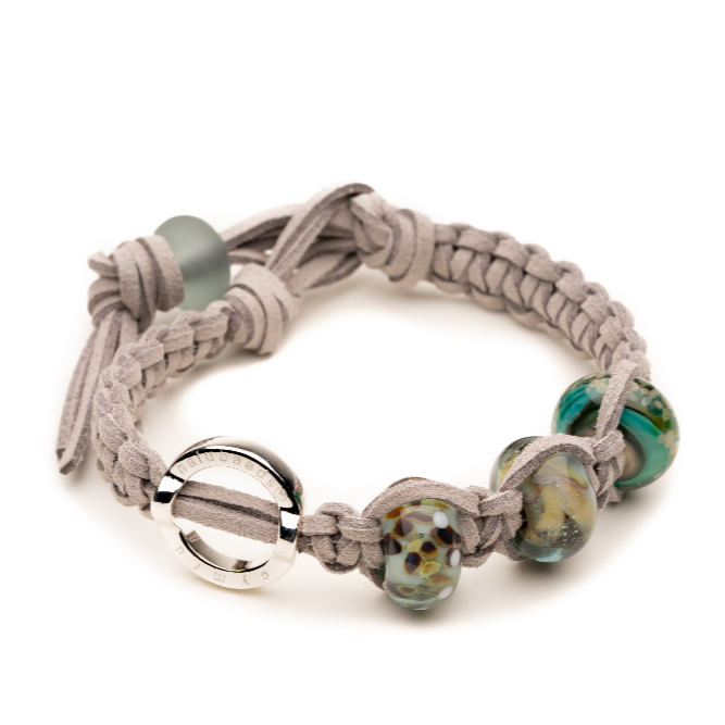 Grey cord bracelet with silver loop charm and glass beads.