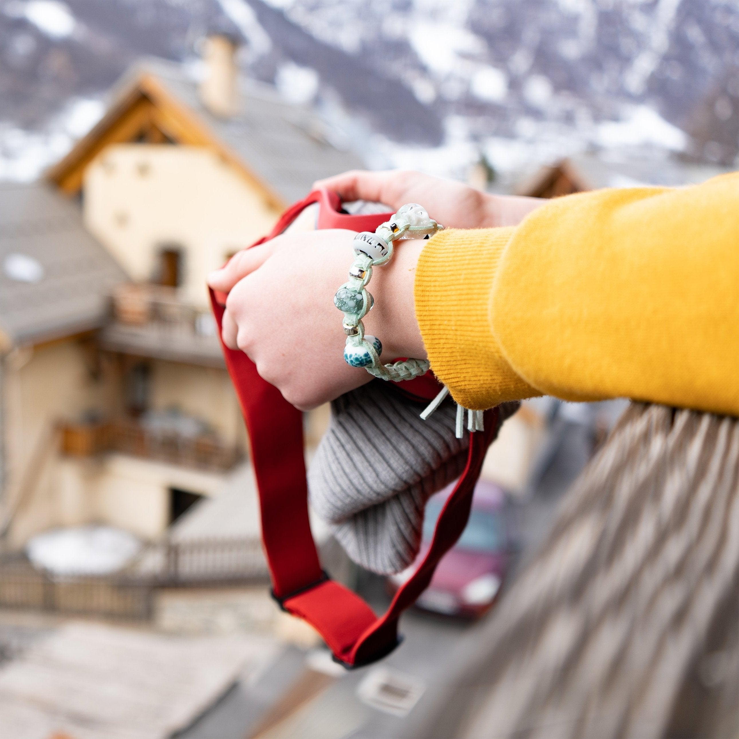 Snow bead bracelet worn by person in the Alps.